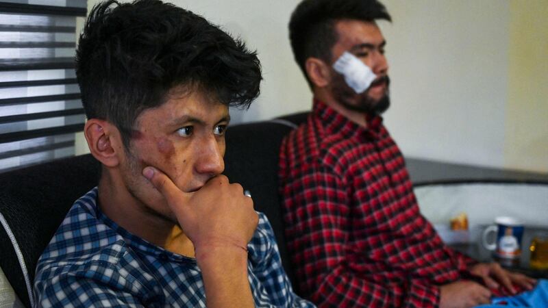 Afghan  journalists Neamat Naqdi (R) and Taqi Daryabi sit in their office after being released from Taliban custody in Kabul. Photograph: Wakil Kohsar/AFP via Getty Images