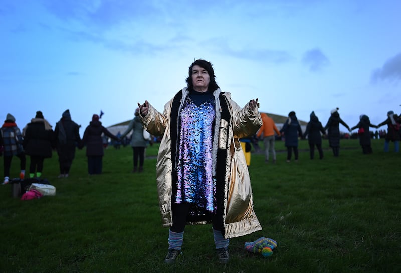 New Age revellers and sun worshippers celebrate the Winter Solstice as the sun rises over Newgrange. Photograph: Charles McQuillan/Getty Images