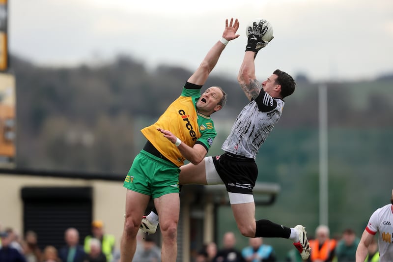 Tyrone's Niall Morgan beats Donegal's Michael Murphy to the ball. Photograph: Bryan Keane/Inpho
