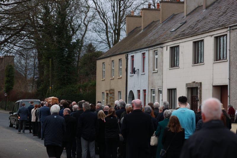 The coffin of Mary Kielty is carried past her family home on Main Street, following her funeral at the Church of the Sacred Heart in Dundrum. Photograph: Liam McBurney/PA Wire