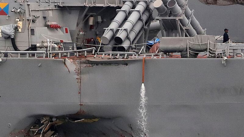 The damaged port aft hull of the USS John S McCain, as the vessel is docked at Singapore’s Changi naval base. Photograph: Wong Maye-E/AP