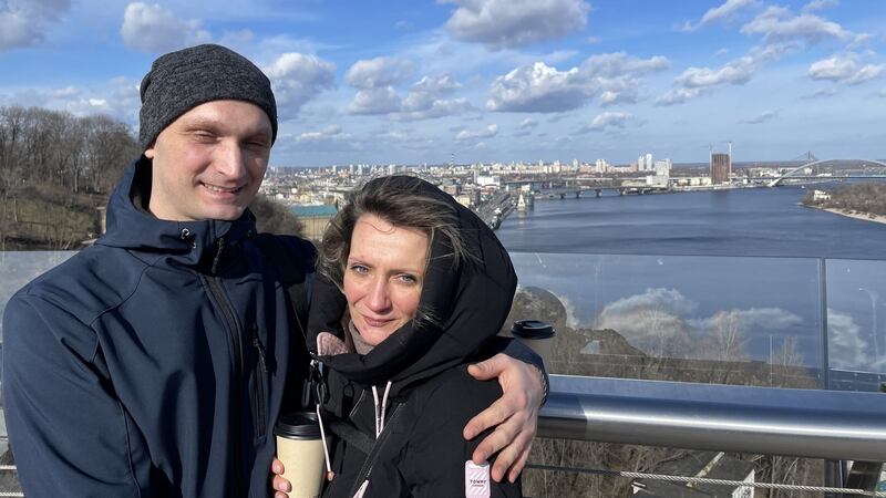 Denis and Ira, a Ukrainian couple visiting their capital, Kyiv, stand on a pedestrian bridge overlooking the Dnieper river. Photograph: Daniel McLaughlin