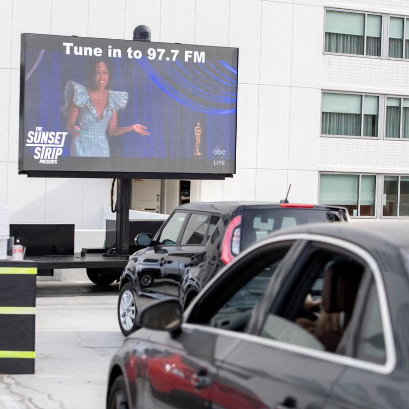 People attend the Sunset Strip Late Night Drive-In Oscars Watch Party On the parking lot of the Andaz Hotel, April 25, 2021 in West Hollywood, California. (Photo by VALERIE MACON / AFP) (Photo by VALERIE MACON/AFP via Getty Images)