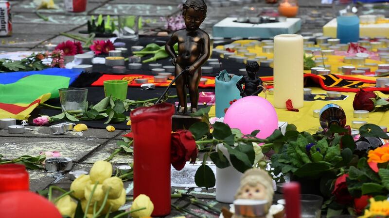 A replica of the Manneken Pis statue stands at a makeshift memorial at Place de la Bourse  in Brussels. Photograph:  Getty