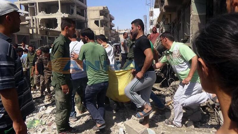 In this photo released by the news outlet ANHA via the Syrian official news agency SANA, Syrians carry a victim after twin bombings struck Kurdish town of Qamishli, Syria. Photograph: SANA via AP