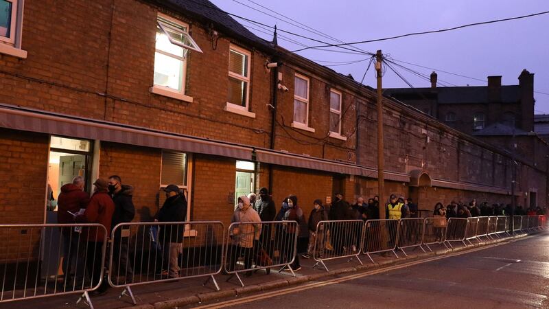 People queue at The Capuchin Day Centre to receive a gift voucher for food this morning on Bow Street in Dublin City centre. Photograph: Damien Eagers