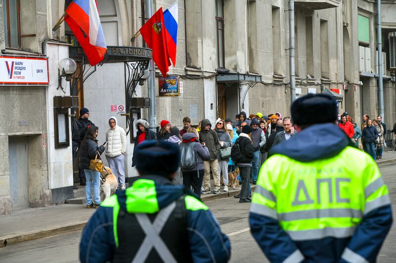 Voters queue at a polling station in Moscow, Russia. Photograph: AP Images