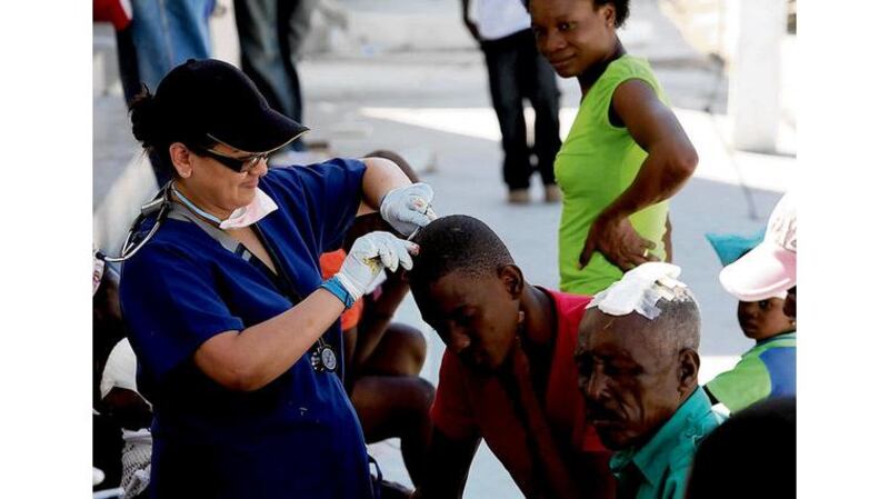 A doctor from the Cuban Medical Centre cares for patients on the street. Photograph: Brenda Fitzsimons