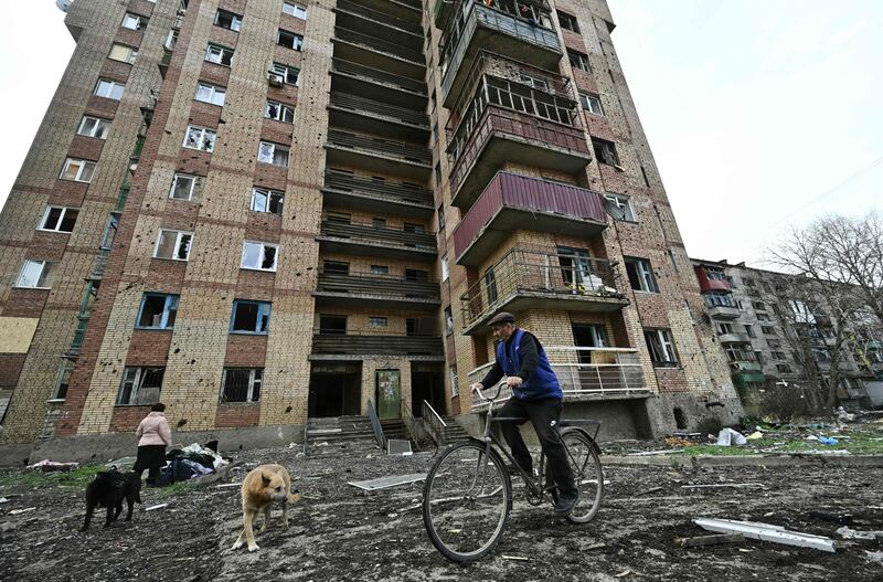 A local resident rides a bicycle next to a damaged residential building after a Russian missile strike in the town of Kostyantynivka, in the Donetsk region. Photograph: Genya Savilov/AFP via Getty Images