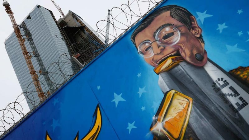 Graffiti depicting European Central Bank president Mario Draghi outside a fence surrounding the construction site for the new headquarters of the ECB in Frankfurt. Photograph: Kai Pfaffenbach/Files/Reuters