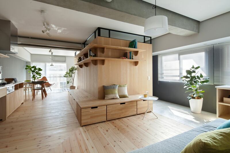 An L-shaped timber partition wall hives off space for two bedrooms in this 64sq m apartment by Sinato in Kanagawa, Japan. Photograph: Toshiyuki Yano