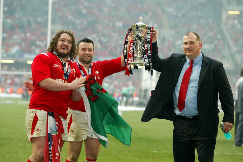 Adam Jones and Mefin Davies celebrate with head coach Mike Ruddock after winning the 2005 Six Nations. Photograph: Morgan Treacy/Inpho