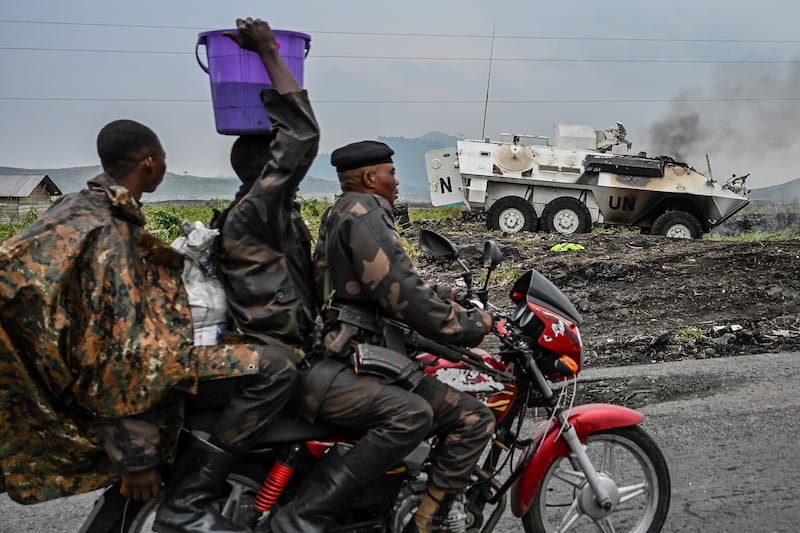 A UN armoured personnel carrier burns on the outskirts of Goma. Photograph: Moses Sawasawa/AP