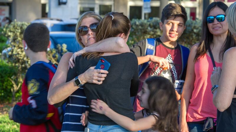 Students are comforted by parents and family after a shooting at Marjory Stoneman Douglas High School in Parkland, Florida. Photograph: Georgio Viera/EPA