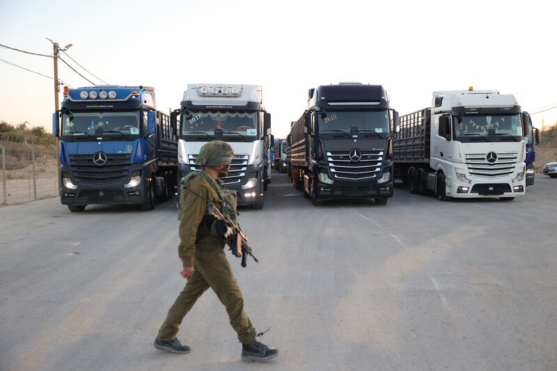 An Israeli soldier walks near Jordanian aid trucks at the Erez crossing on the border with northern Gaza Strip, in southern Israel on Monday. Photograph: Abir Sultan/EPA