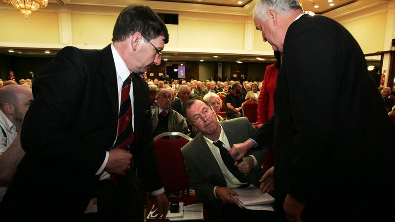 Security staff cover the microphone of shareholder Patrick Kehoe fron Wexford at the 2005 AIB Group AGM in Dublin. Mr Kehoe was asked to to leave the meeting after the AIB chairman Dermot Gleeson deemed that he was disrupting the meeting. Photograph: Frank Miller