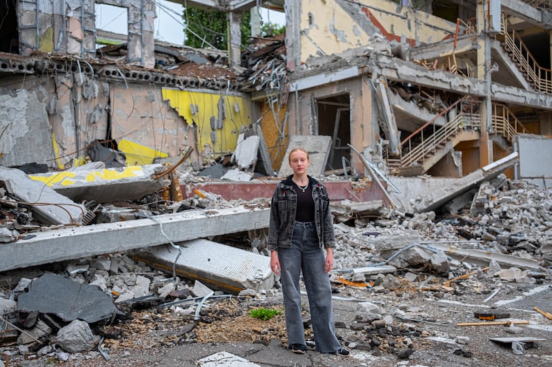 Mariia (12) in front of a school in Kharkiv, Ukraine, which was destroyed in an air strike. Photograph: Unicef