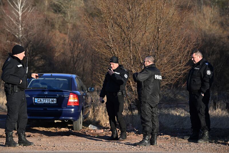 Security officials on the outskirts of the village of Lokorsko, after the discovery of 18 dead migrants in the rear of an abandoned truck. Photograph: Nikolay Doychinov/AFP/Getty