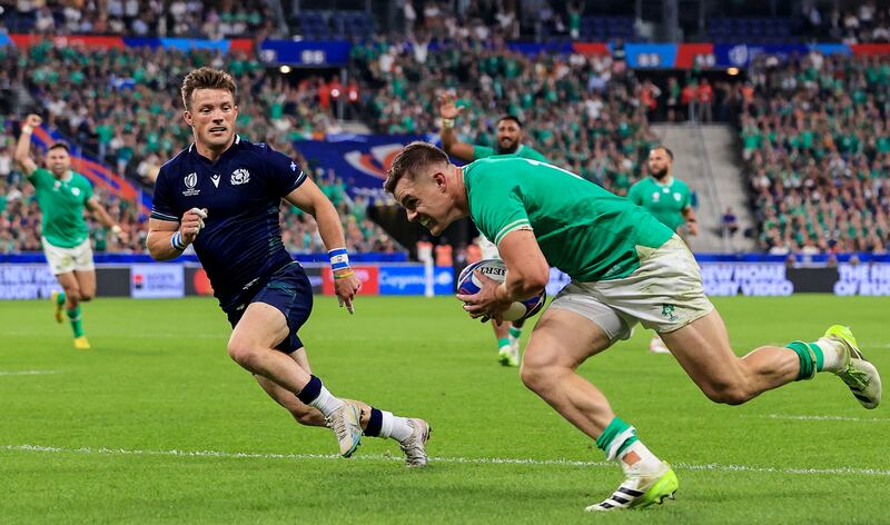 Scotland's George Horne watches as Ireland's Garry Ringrose goes over for a try. Photograph: Dan Sheridan/Inpho