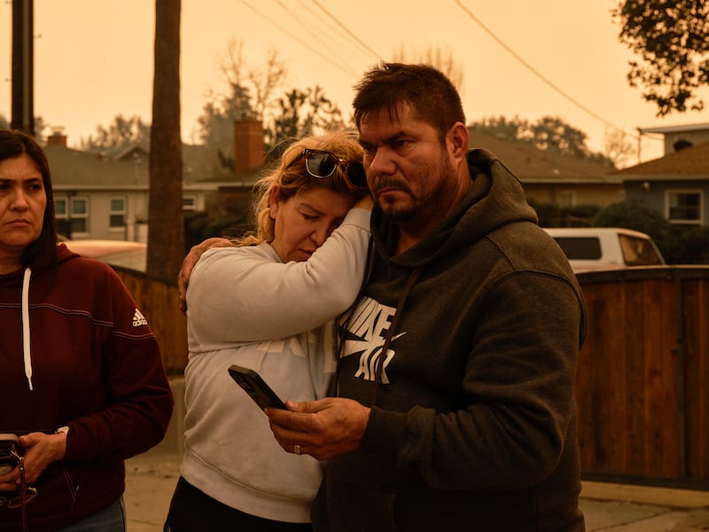 Jose Torres hugs his wife, Ivette Sedano, after their home was destroyed in the Eaton fire in Pasadena, California. Photograph: Philip Cheung/New York Times
                      