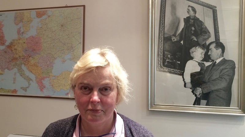 Walburga Habsburg Douglas, who spoke on behalf of her father Otto at the Pan-European Picnic  in 1989. She stands in front of a photograph of Otto holding her brother Karl, before a portrait of Emperor Karl I of Austria. Photograph: Daniel McLaughlin