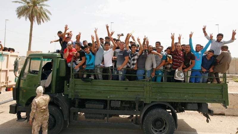 Volunteers who have joined the Iraqi Army to fight against the predominantly Sunni militants, who have taken over Mosul and other Northern provinces, gesture from an army truck in Baghdad. Photograph: Ahmed Saad/Reuters