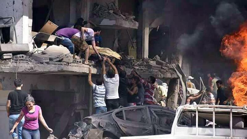 In this photo released by the Syrian official news agency SANA, Syrians carry the body of a victim from a building damaged in twin bombings struck Kurdish town of Qamishli, Syria. Photograph: SANA via AP