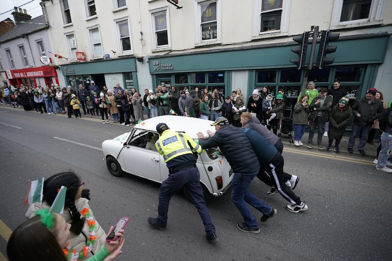 A classic mini that broke down is pushed during the St Patrick's Day parade in Athy, Co Kildare. Photograph: Niall Carson/PA Wire