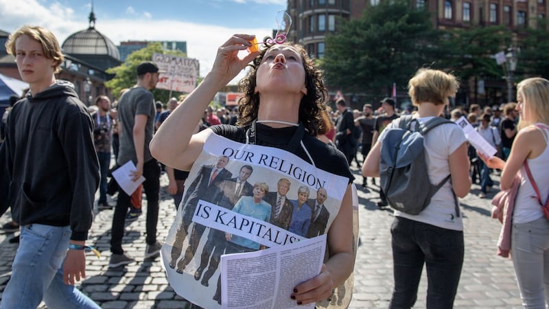 A woman blows bubbles  at  a demonstration in Hamburg  prior to the G20 summit in the Germany city. Photograph: Thomas Lohnes/Getty Images