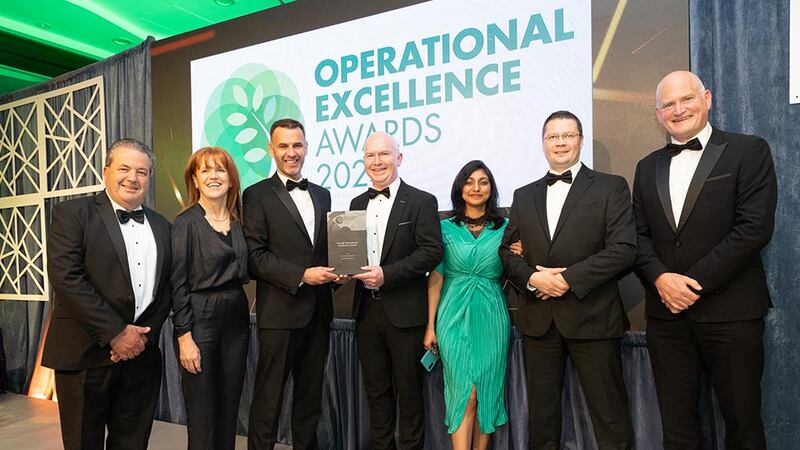 Eric Clinton, awards judge, presents the overall operational excellence award to An Post Commerce team