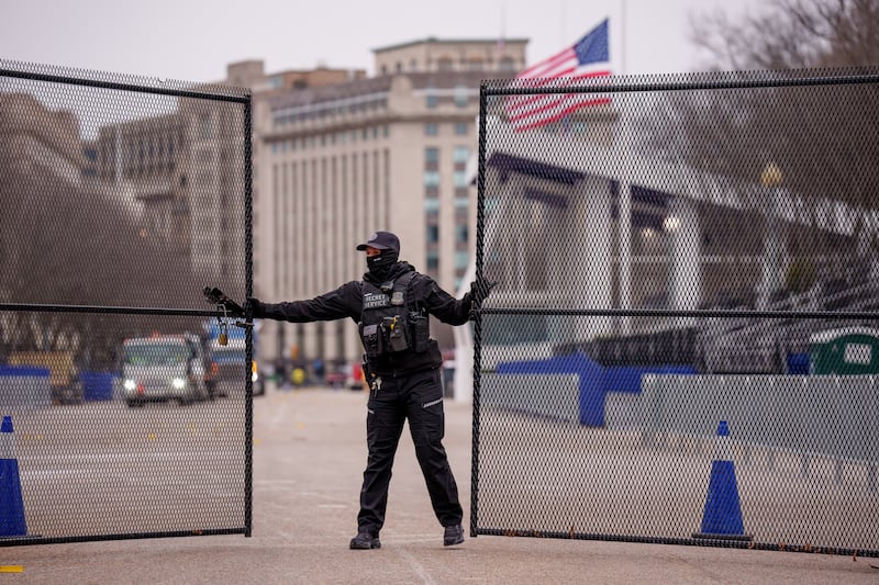 A member of the US Secret Service closes a security gate near the presidential inauguration parade review stand on Pennsylvania Avenue, Washington DC, on Thursday. Photograph: Andrew Harnik/Getty