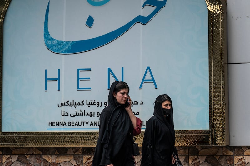 Women walks past a beauty salon at the Shahr-e Naw area in Kabul on Tuesday. Photograph: Wakil Kohsar/AFP via Getty Images