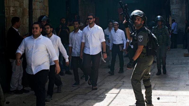 Israeli border police guarding religious Jews passage in the alleys leading to Al-Aqsa mosque compound in the old City of Jerusalem. Photograph:  Atef Safadi/EPA