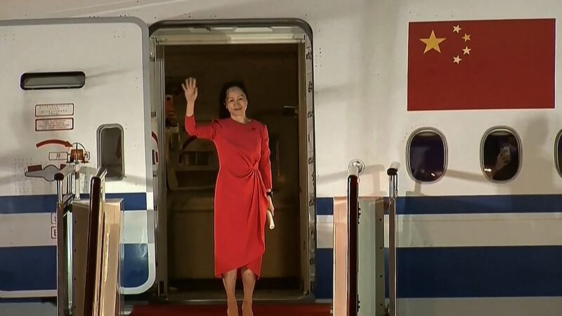 Huawei executive Meng Wanzhou waves as she steps out of a plane upon arrival in Shenzhen in China. Photograph: CCTV/AFP via Getty Images