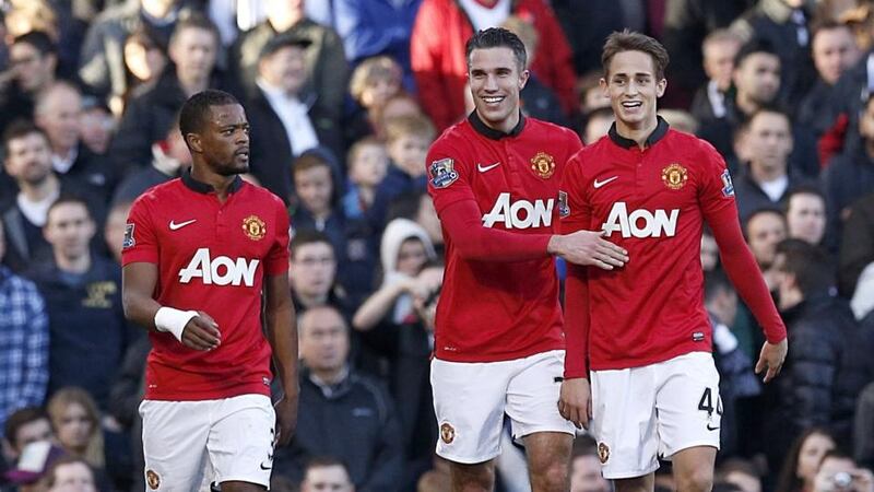 Manchester United’s Robin van Persie (centre) celebrates scoring his team’s second goal of the game alongside teammates Adnan Januzaj (right) and Patrice Evra (left) at   Craven Cottage. Photograph: Jonathan Brady/PA Wire