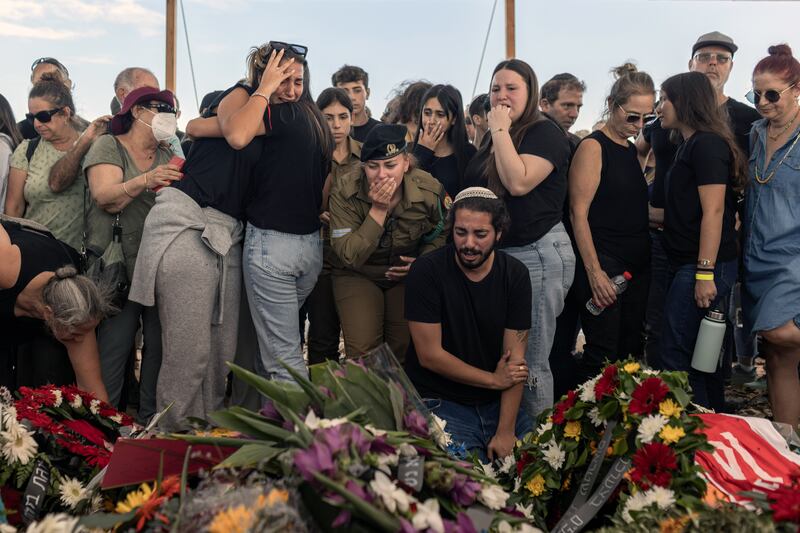 Mourners gather around the five coffins of the Kotz family during their funeral in Gan Yavne, Israel, on October 17th, 10 days after they were killed in the Hamas attack on the kibbutz of Kfar Aza. Photograph: Avishag Shar-Yashuv/New York Times
                      