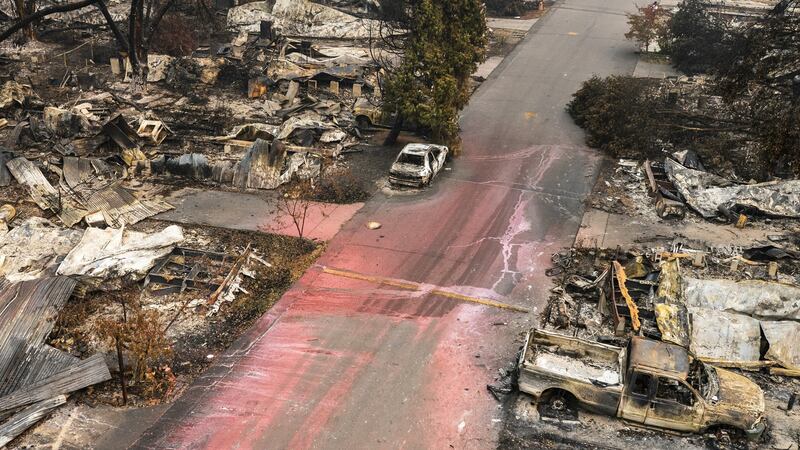 The remains of homes and vehicles in Talent after the Almeda fire. Photograph:  Nathan Howard/Getty Images