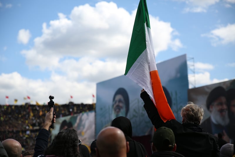 Tara Reynor O’Grady holds up an Irish flag during the funerals of Hassan Nasrallah and Hashem Safieddine on Sunday in Beruit. Photograph: Sally Hayden