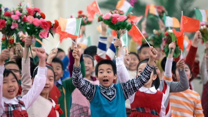 Chinese children holding Ireland and China flags and flowers practice their cheer before a welcome ceremony for President Michael D Higgins  in Beijing. Photograph: Rolex Dela Pena/EPA