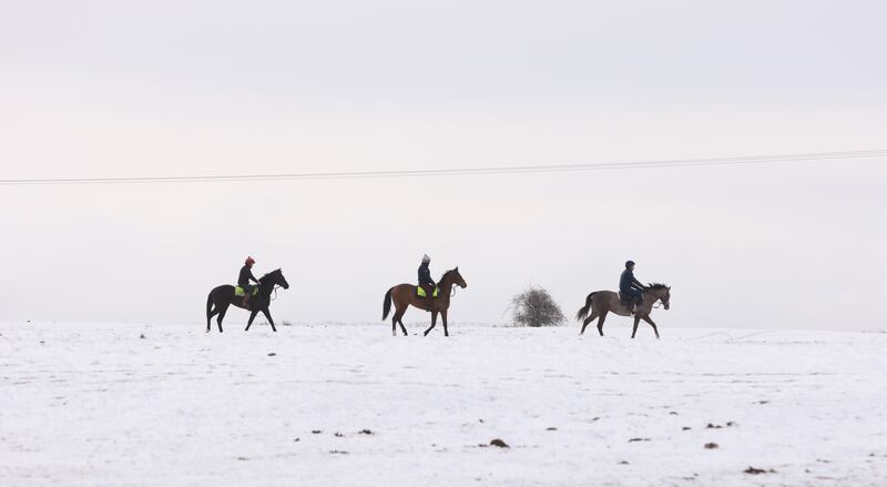 Horses and riders experience a whiteout as they exercise on the snow-covered Curragh Plains in Co Kildare on Friday. Photograph: Eamonn Farrell/RollingNews.ie