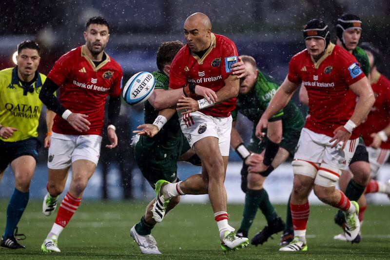 Munster's Simon Zebo offloads in a tackle from Cian Prendergast of Connacht. Photograph: Ben Brady/Inpho