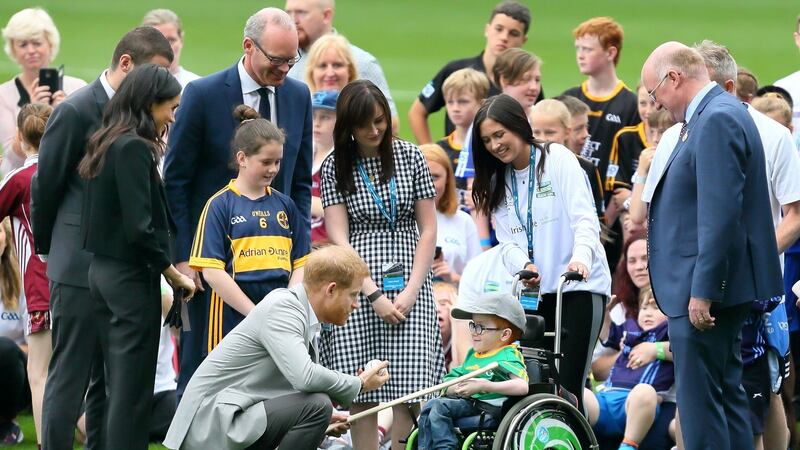 Nathan Charney-Kiely presents  Prince Harry and wife Meghan, Duke and Duchess of Sussex with a hurley as they visit Croke Park. Photograph: Getty Images