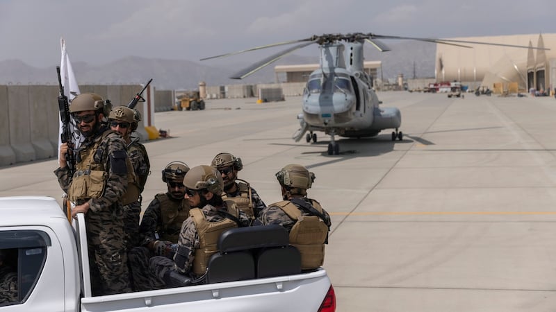 Taliban fighters secured helicopters that had been disabled and left behind by American forces. Photograph: Victor J Blue/The New York Times