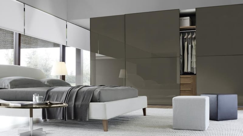 Custom-made Jesse wardrobes, from LOMI Design, with sliding doors in matt lacquer with café lacquered glass