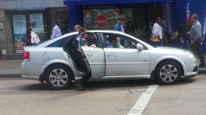 Sir Bernard  (front passenger seat) and his bodyguard (back seat) jumping into a taxi to pursue a suspect after the driver complained his passengers refused to pay the fare and had stolen cash from him. Photograph: BBC London 94.9/PA