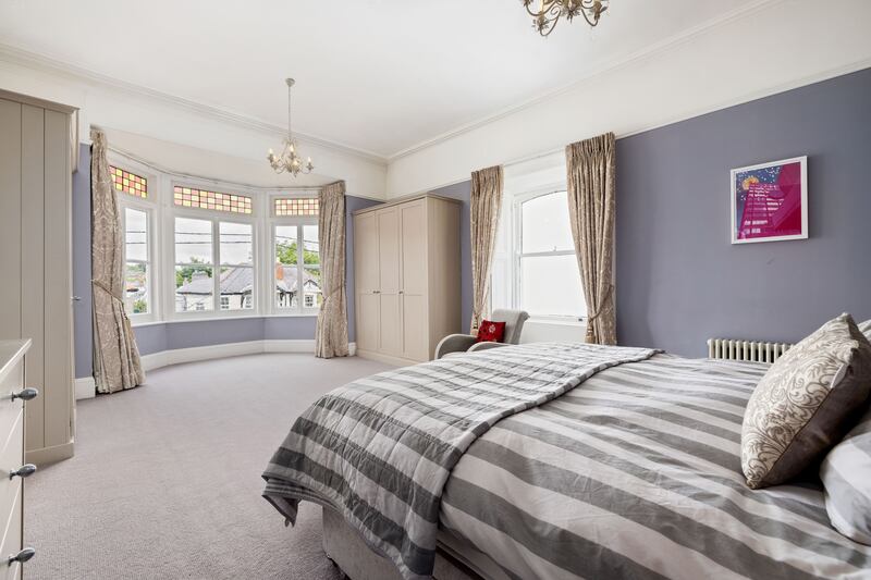 Main bedroom with bay window and custom-built wardrobes