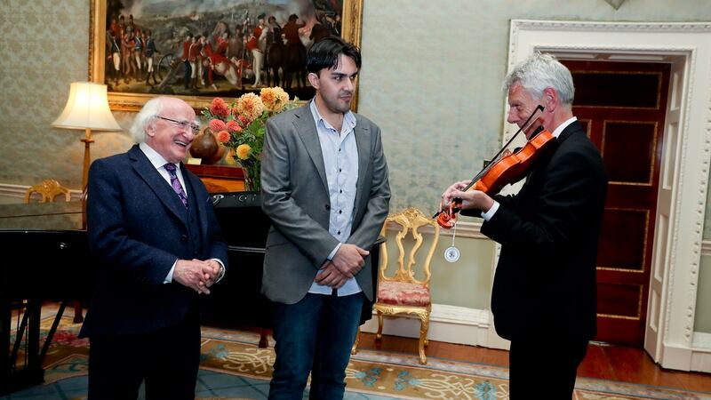 Stockton’s Wing fiddle player Maurice Lennon plays Mr Loulah’s violin for the President. Photograph: Maxwells