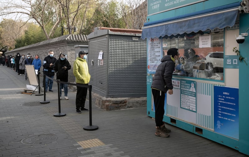 Residents queue at a Covid-19 testing booth in Beijing. Photograph: Bloomberg