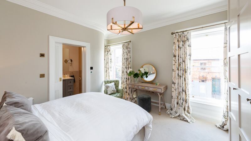 Main bedroom, with two large sash windows, had a small en suite and walk-in wardrobe which were combined by Crean Salley Architects to become one large bathroom with a roof light. Photograph: Matteo Tuniz