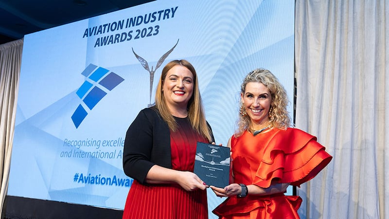 Marina Efthymiou, awards judging co-ordinator, presents the workplace achievement award to Stephanie Brady, Retail inMotion